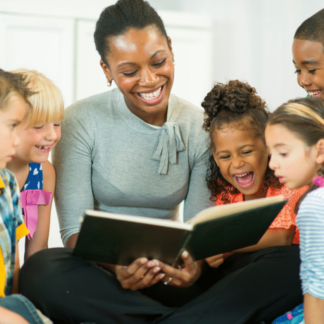 woman reading to a group of children.